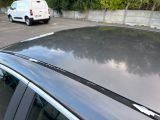 cars parked in a parking lot with trees in the background