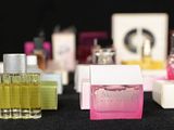 bottles of perfume are lined up on a table with a black background
