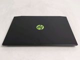a black laptop with a green sticker on it