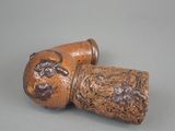 a small wooden object with a design on it