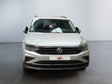 the front of a white volkswagen suv parked in a showroom