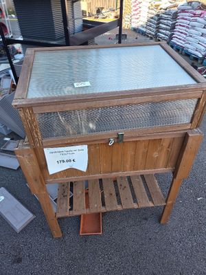 a wooden table with a glass top on the street