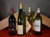 several bottles of wine are lined up on a red table