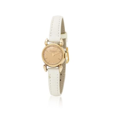 a close up of a wrist watch on a white surface