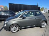 the small car is parked in the parking lot next to other cars