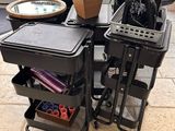a table with a lot of hair dryers and other items on it