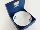 a blue box with a white bowl inside of it