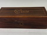 a close up of a wooden box with a name on it