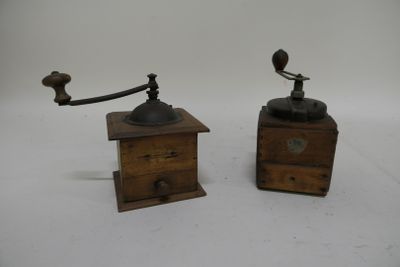 pair of antique wooden coffee grinders on a white background