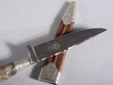 a knife and a pair of shavings next to each other
