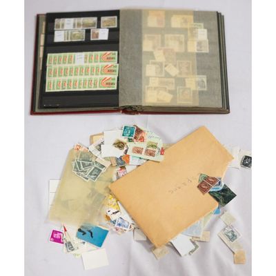 an open book sitting on top of a table covered in stamps