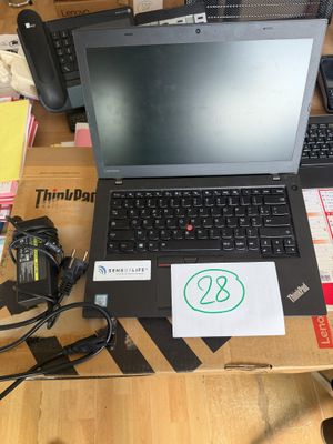 a laptop computer sitting on top of a wooden table