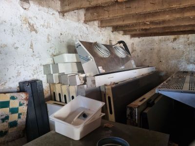 a pile of old appliances in a dirty room