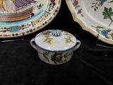 two plates and a bowl on a black table