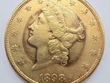 a close up of a gold coin with a woman ' s head on it