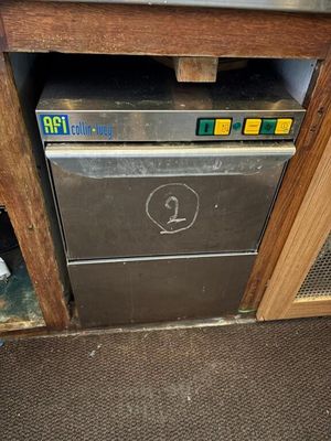 a silver dishwasher sitting in the corner of a kitchen