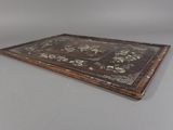 a wooden tray with a floral design on it