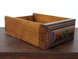 a wooden box with a drawer on top of it