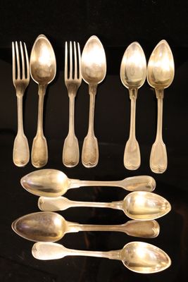 a lot of silver spoons and spoon spoons on a table