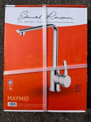 a close up of a box of a kitchen faucet on a floor