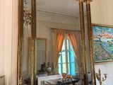 a large mirror on a mantle in a room