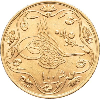une image montrant un gros plan d'une pièce d'or sur laquelle figure un oiseau