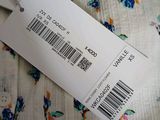 a label on a bed with a floral pattern on it