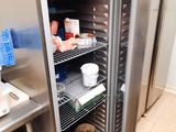 a stainless steel refrigerator in a kitchen with a lot of food in it