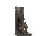 statue of a man and a dog on a bookend