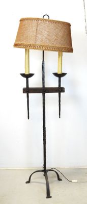 a lamp that is on a stand with a lamp shade on it