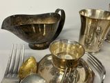 a silver plate with silverware and silverware on it