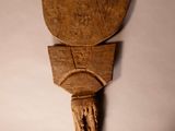 a wooden sculpture of a man ' s head on a wall