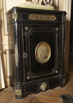 a black and gold cabinet with a clock on top of it