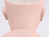pink ceramic vase with a man ' s head on the top of it
