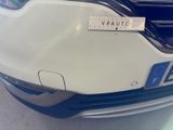 a white car with a sticker on it ' s bumper