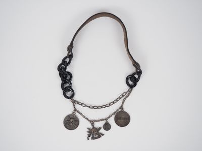 a close up of a necklace on a white surface