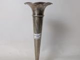 a silver vase that is sitting on a table