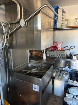 a kitchen with a sink, stove, and other items in it