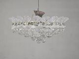 a glass chandelier hanging from a ceiling in a room