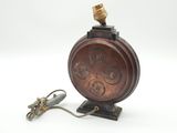an old fashioned lamp with a cord plugged to it