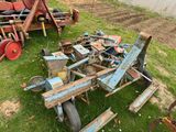 a pile of old machinery sitting in the grass