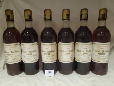 six bottles of wine are lined up in a row on a table