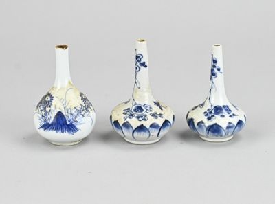 three blue and white vases sitting next to each other on a table