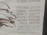 a poster on the wall of a building advertising a movie