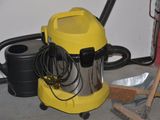a yellow and black vacuum and a broom on the floor