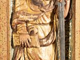 statue of a man holding a sword and a sword in a wooden frame