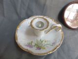 a tea pot and saucer sitting on a table