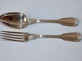 two silver spoons and a fork on a table