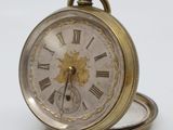a gold pocket watch with roman numerals on the face