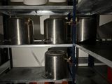 many pots and pans on the shelves in the kitchen